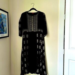 Black with white and red embroidery.  Empire waist, dress up or just as it is.